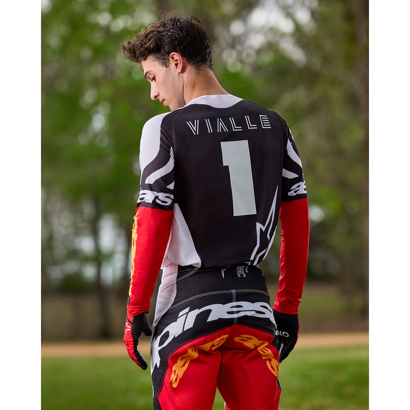 Camiseta de motocross Alpinestars Techstar edición limitada en negro intenso, blanco, rojo fluorescente y naranja.